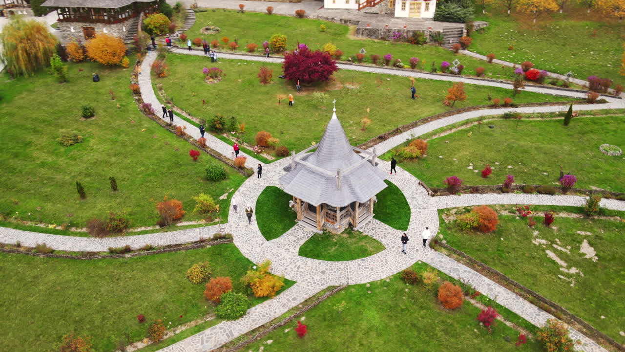 Aerial drone view of the Barsana Monastery, Romania. Inner court with walking visitors