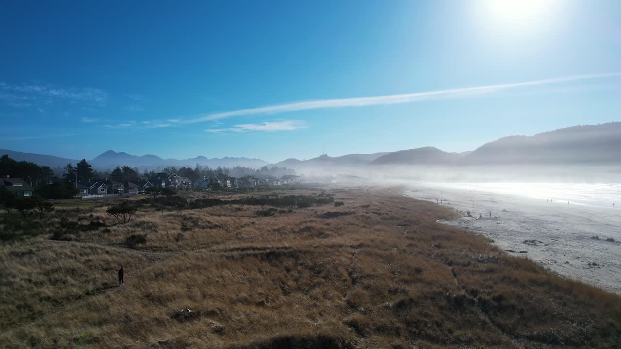 Foggy Beach Town with Mountain View