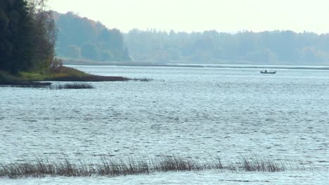 a boat crossing river daugava near katlakalns