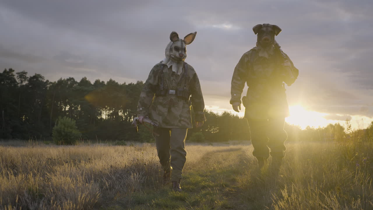 Soldiers with Animal Masks Walking in Field at Sunset