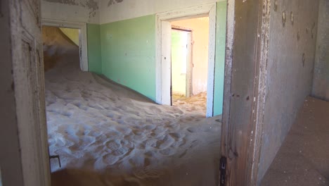 sand fills an abandoned building in the gem mining ghost town of kolmanskop namibia 3
