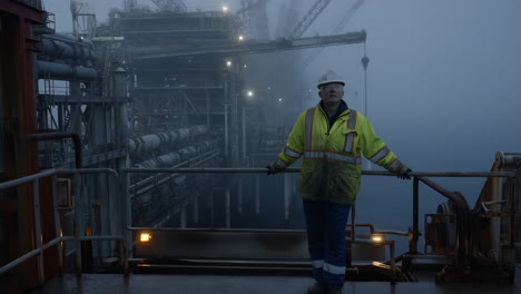 worker on an offshore oil rig in foggy conditions