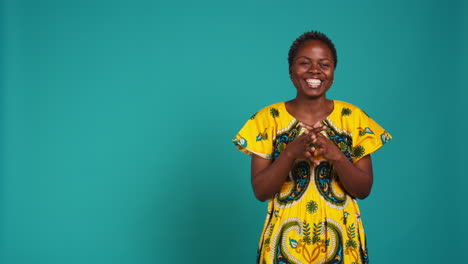 Cheerful-feminine-girl-having-a-laugh-posing-against-blue-background