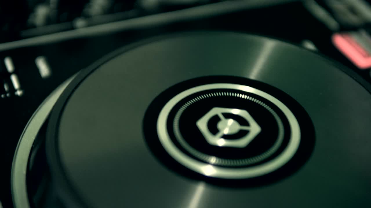 DJ tweak track controls on DJ control panel.