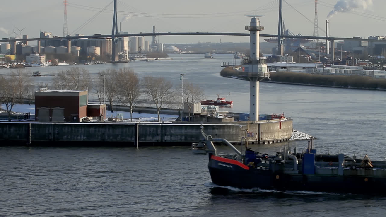 ship on river in the port of hamburg with the famous kohlbrand bridge in the background