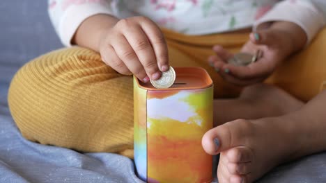 Child-girl-pile-coin-for-saving