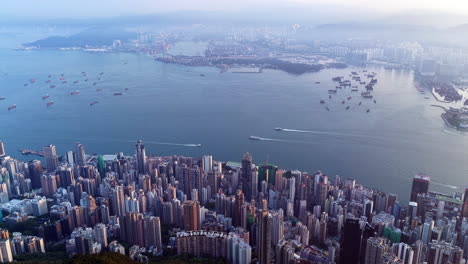 cinematic aerial view of the hong kong skyline in morning light with cloud cover, showcasing the metropolitan city as a symbol of global finance, modern architecture, travel, and business