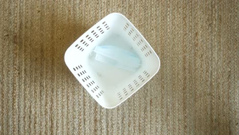 white square plastic basket with face masks