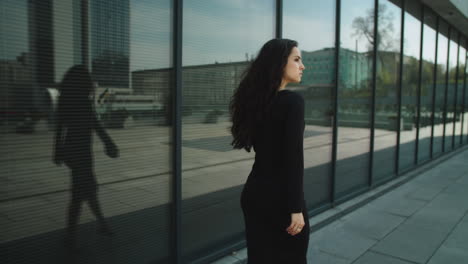 pretty woman looking away in luxury dress at street.