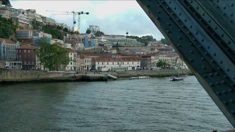 footage from the bridge in porto, of the cable cars by the river