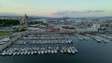 Aerial-tracking-shot-of-the-industrial-harbor-of-Isla-Verde,-dusk-in-Algeciras,-Spain