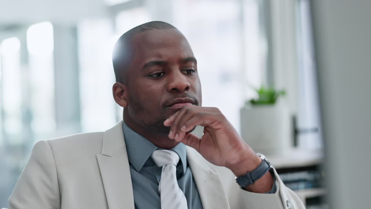 Business, black man and thinking at computer