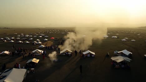 aerial view of a campsite with many tents and people