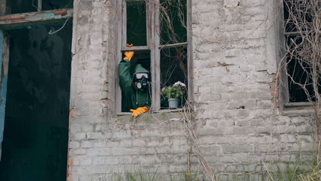 person in radioactive suit in abandoned creepy place. apocalypse broken architecture.