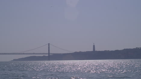 lisbon bridge statue, shot by boat