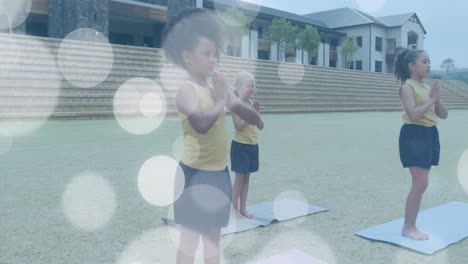 animation of white light spots over happy diverse doing yoga in outdoor class