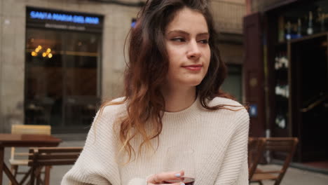 concerned girl drinking red wine on cafe terrace