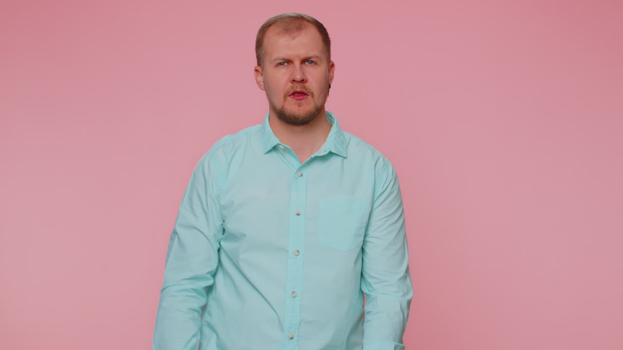 Upset man in casual shirt showing thumbs down sign gesture disapproval dissatisfied dislike