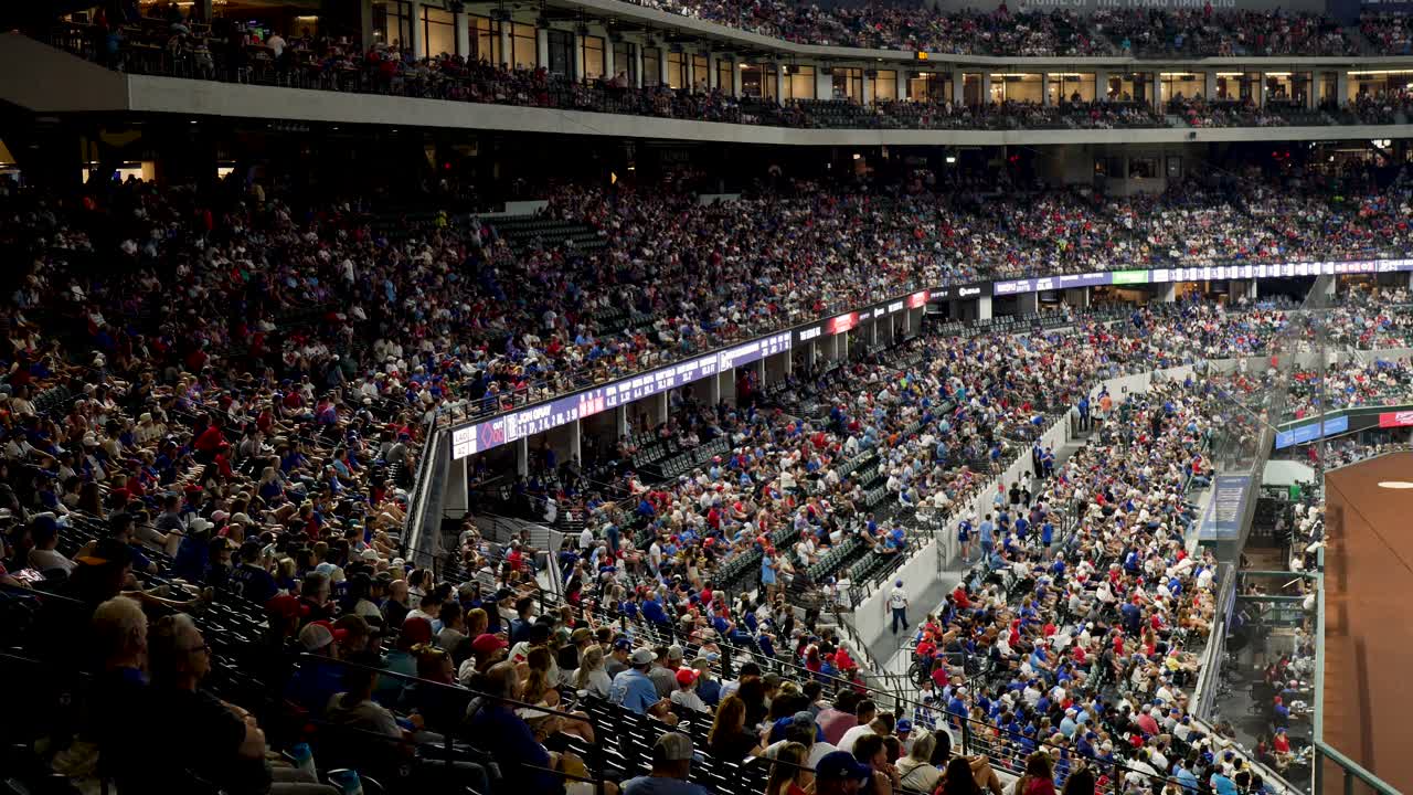 Slow motion landscape of baseball stadium field grandstand filled with fans and supporters at major league sports game in park Arlington Dallas Texas USA America