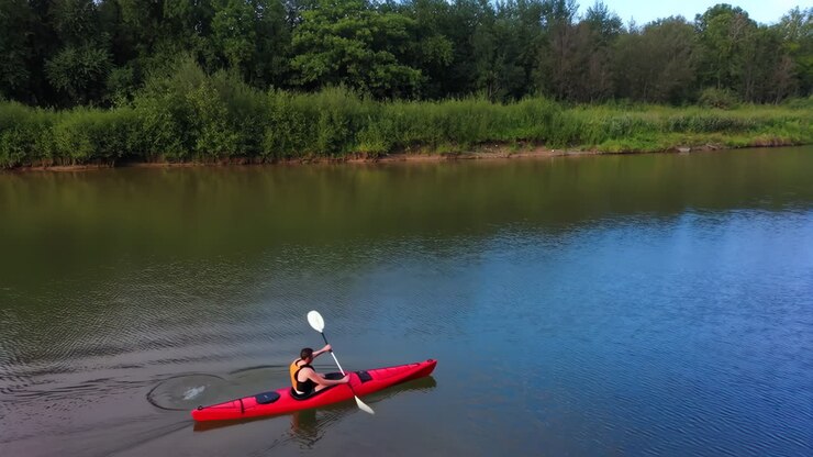Person Kayaking on a River