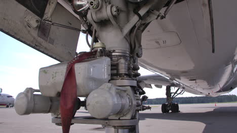 close up airplane landing gear on tarmac