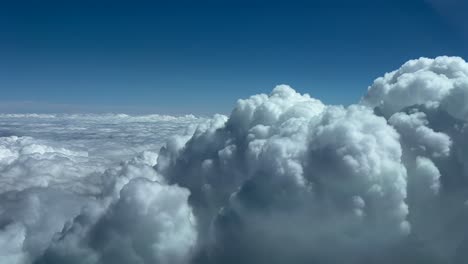 POV-flying-near-the-top-of-a-huge-cumulonimbus-stormy-cloud,-as-seen-by-the-pilots-of-a-jet