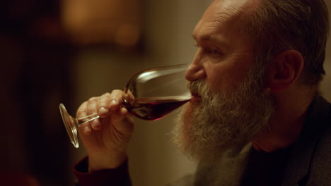 Old-aged-man-drinking-red-wine-glass-in-restaurant.-Grandfather-retirement