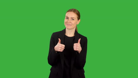 Business-woman-in-black-suit-giving-two-thumbs-up-on-green-screen