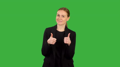 business woman in black suit giving two thumbs up on green screen