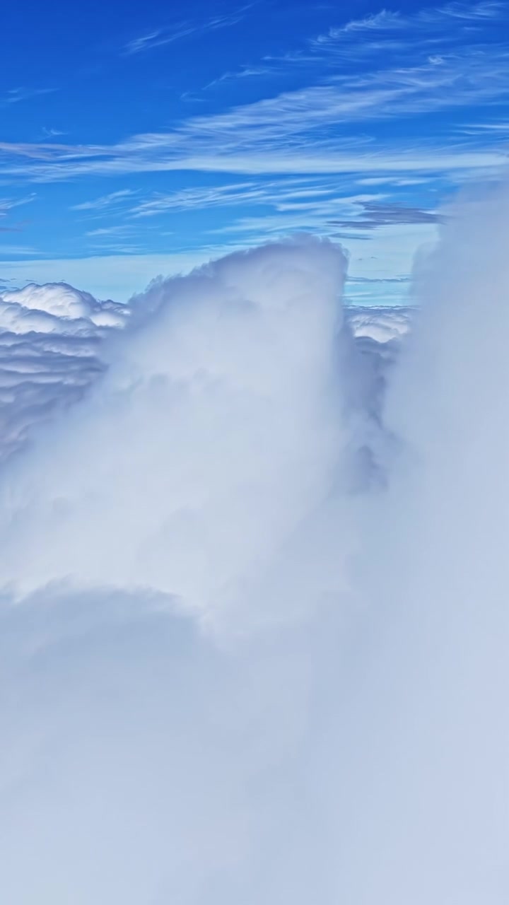 Vertical View Of White Fluffy Clouds In The Sky. - aerial shot