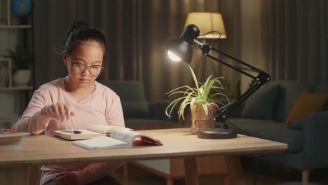 tired teenage girl feel pain eyestrain holding glasses rubbing dry irritated eyes fatigued from doing home work, stressed asia teen girl suffer from headache bad vision sight problem sit at home table