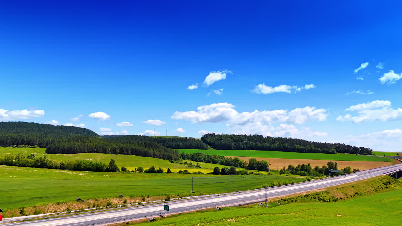 Stunning nature of Slovakia on sunny day. Drone footage approaching a highway crossing the countryside