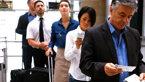 Commuters standing in queue for check-in