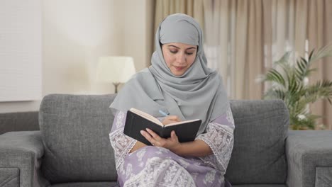 happy muslim woman writing diary