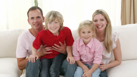 Family-watching-television-at-home-celebrating-a-success-in-a-match