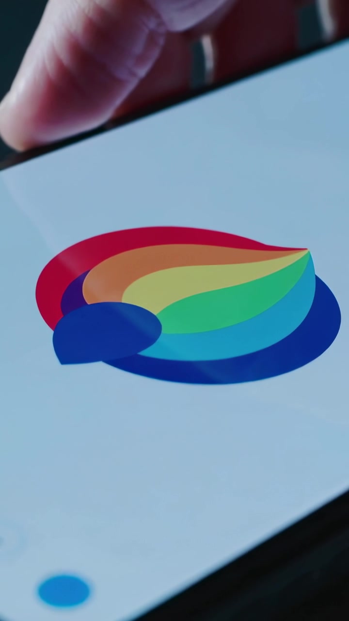Vertical video: Entering bare finger pressing phone screen at table, revealing app logo and ring