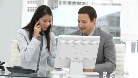Asian-business-woman-with-her-colleague-on-phone