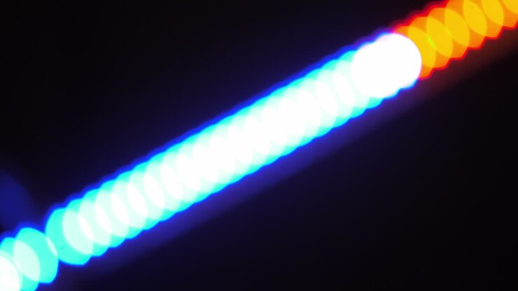 Bokeh shot of defocused blurred christmas tree light that is blinking on black
