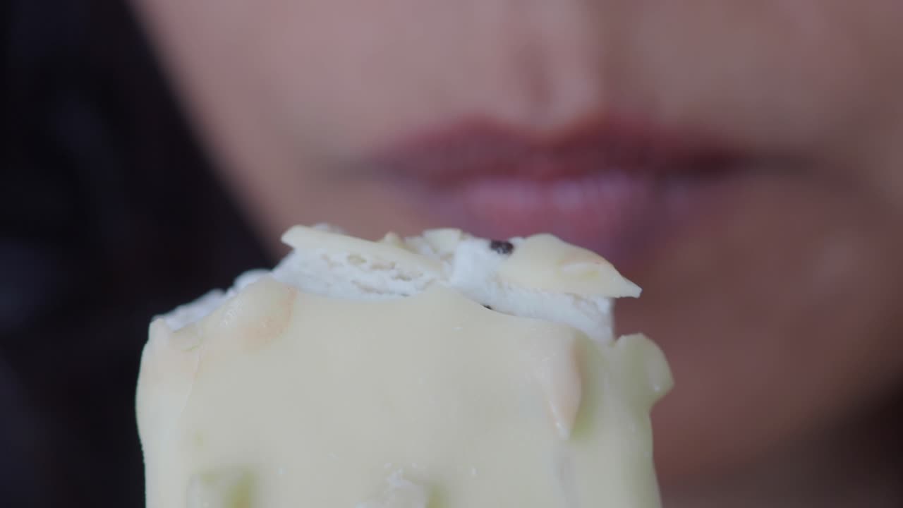Close-up of a person eating white chocolate ice cream