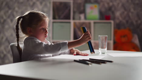 Talented-girl-draws-picture-with-crayons-bunch-in-room