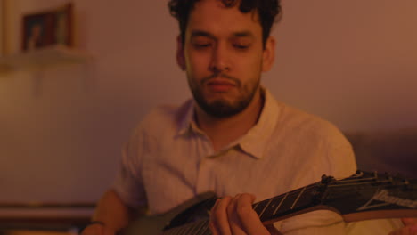 man playing guitar indoors
