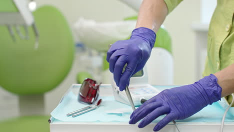 close up dentist hands with dentistry tools