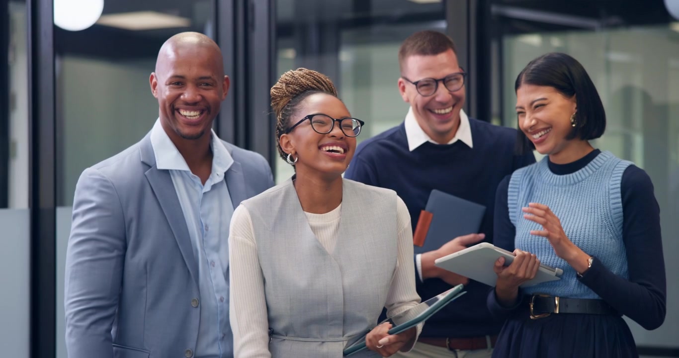 Diverse Group of Business Professionals Laughing Together in Modern Office