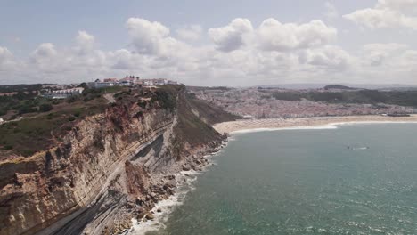 aerial panoramic view nazaré coastline, village and endless sandy beach - portugal