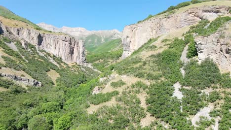 aerial view of a rugged canyon and a mountain range in the distance