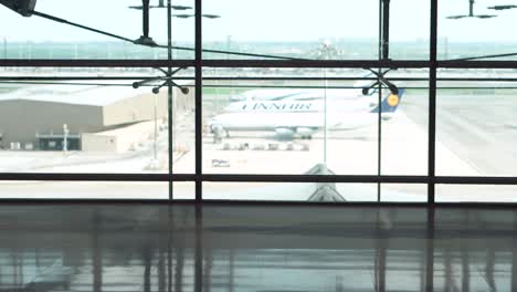 male young passenger walking with suitcase luggage in departure area of airport terminal. asian businessman in casual clothing on business trip. modern travel lifestyle concepts.