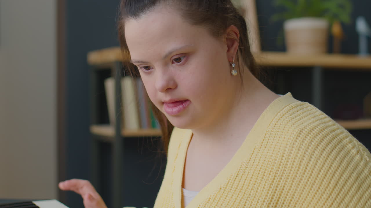 Girl with Down Syndrome Playing Synthesizer