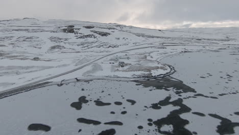 Dolly-forward-towards-house-on-frozen-fjord