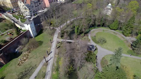 city park with a river in the historic part of olomouc and walls and towers