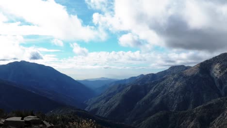 mountain valley shot in real time with clouds passing by in the background
